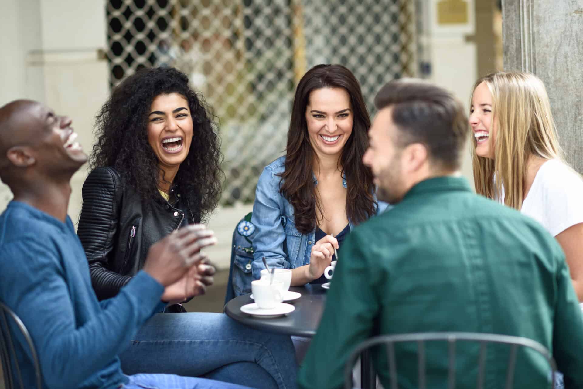 Multiracial group of five friends having a coffee together