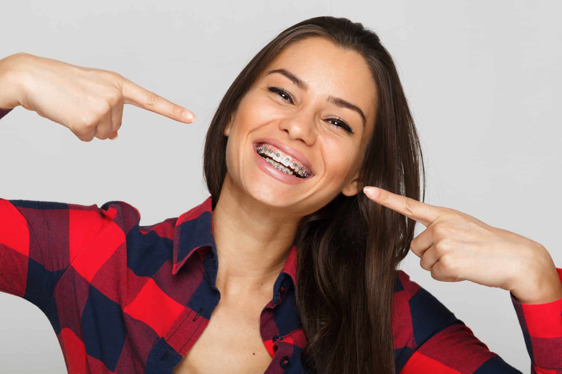 Face of a young woman with braces on her teeth