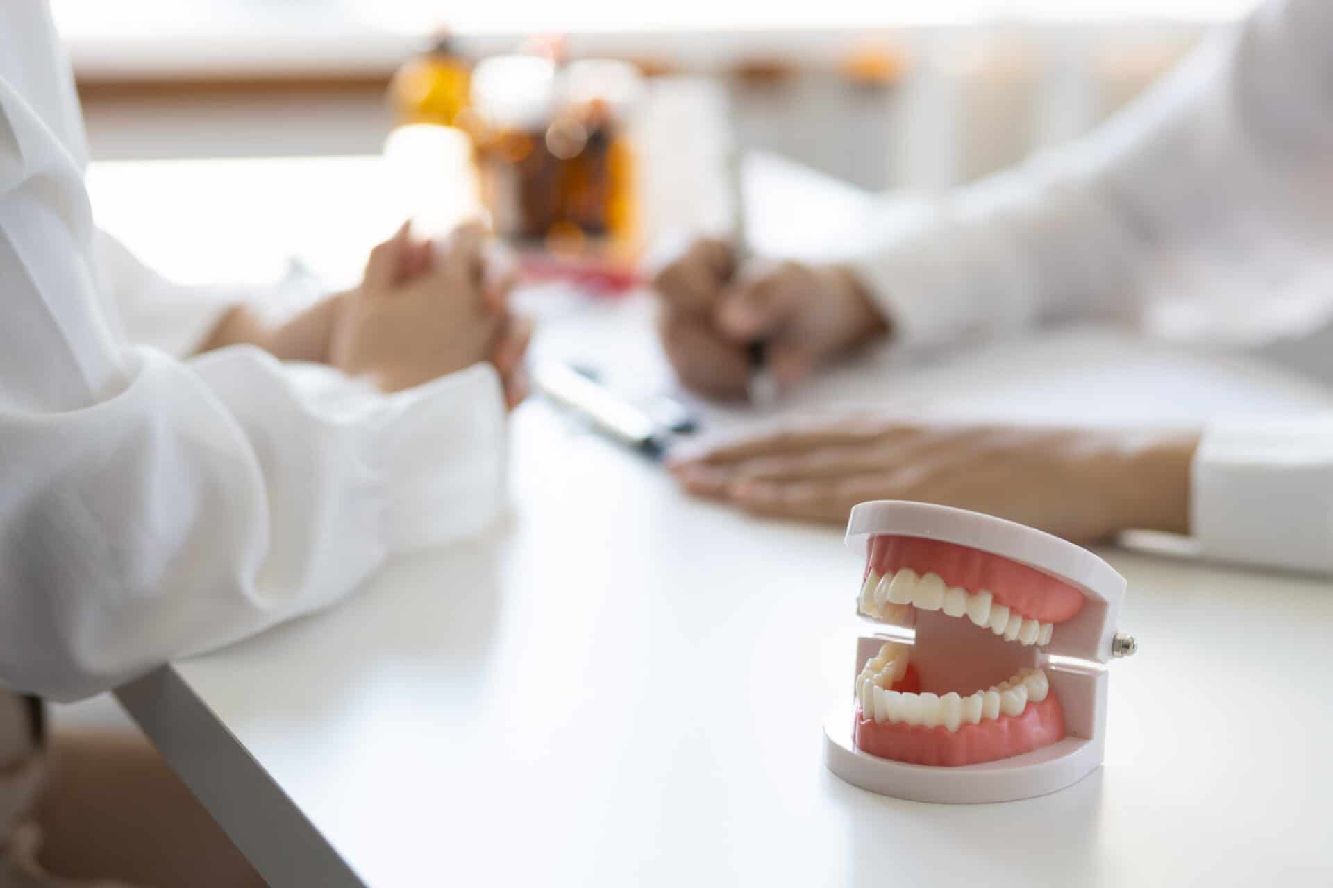 Patient with a toothache sees a dentist in a dental clinic at a hospital examination room. The doctor gives advice on maintaining oral health.