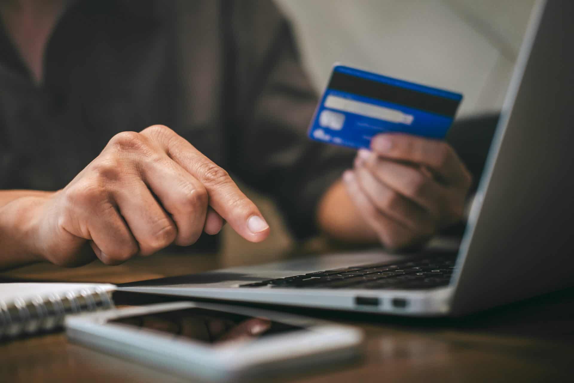 Businessman holding credit card and typing on laptop for online shopping and payment makes a purchase on the Internet, Online payment, Business financial and technology