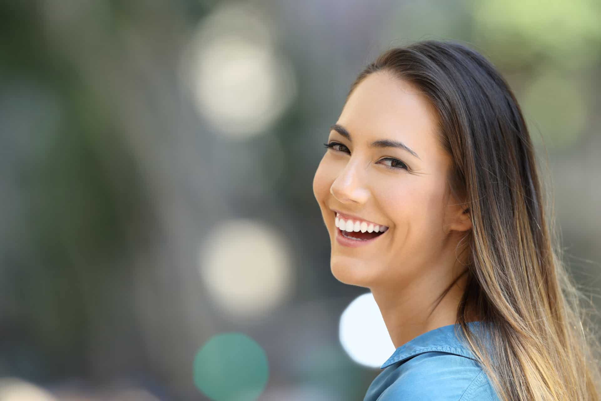 Beauty girl smiling with perfect teeth on the street